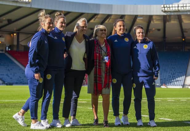Rose Reilly poses with Scotland head coach Shelley Kerr and players Jo Love, Rachel Corsie, Lee Alexander and Joelle Murray before the Jamaica game. Picture: Ross Parker/SNS