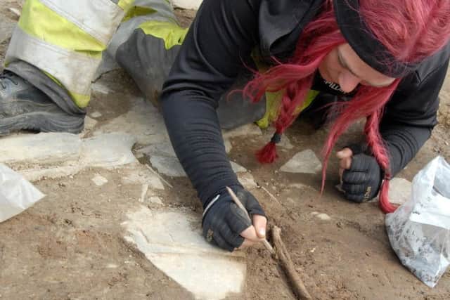 Human bone specialist Andy Boyar carefully excavates the bone. PIC: Ole Thoenies.