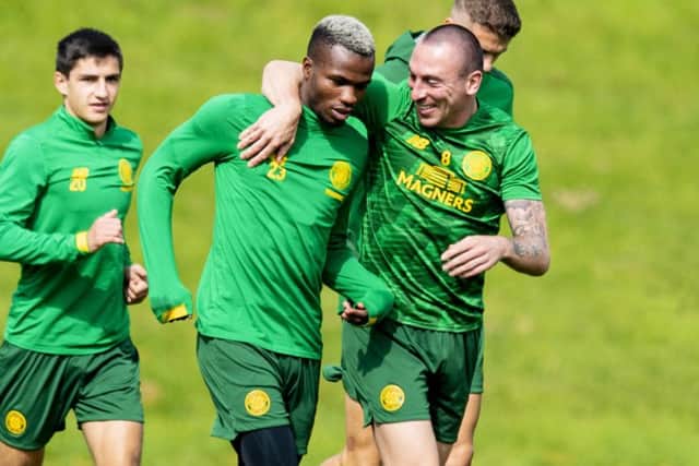 Celtic captain Scott Brown puts an arm around Boli Bolingoli-Mbombo ahead of the Europa League qualifier against AIK. Picture: Craig Williamson/SNS