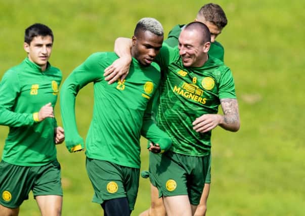 Celtic captain Scott Brown puts an arm around Boli Bolingoli-Mbombo ahead of the Europa League qualifier against AIK. Picture: Craig Williamson/SNS