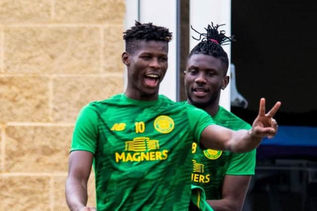 Vakoun Issouf Bayo looks relaxed at Lennoxtown as he heads out for training with Eboue Kouassi
