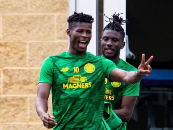 Vakoun Issouf Bayo looks relaxed at Lennoxtown as he heads out for training with Eboue Kouassi