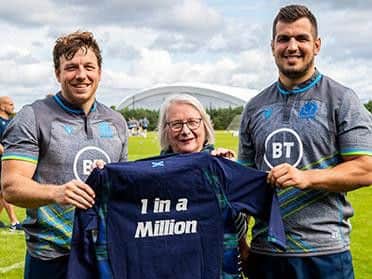 Hamish Watson (left) and Stuart McInally present Isobel Kerr with her commemorative shirt