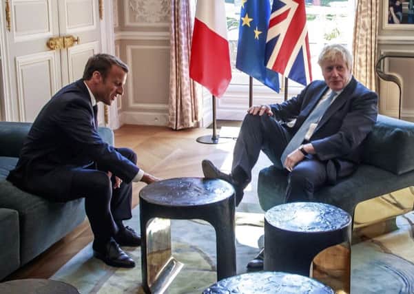 French president Emmanuel Macron, left, talks to Britain's Prime Minister Boris Johnson during their meeting at the Elysee Palace. Picture: Christophe Petit Tesson, Pool via AP