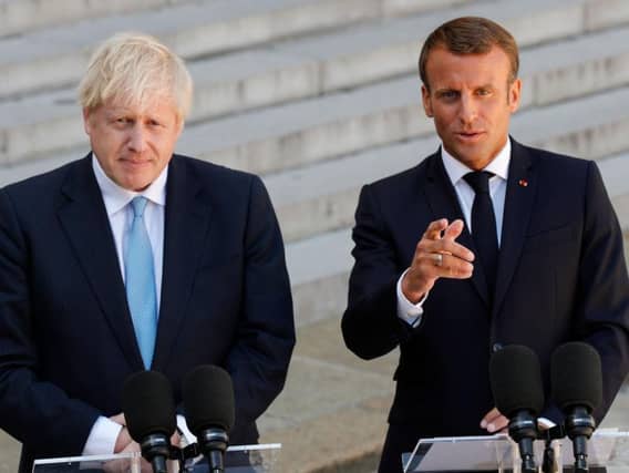 Boris Johnson gives a press conference alongside Emmanuel Macron ahead of private talks