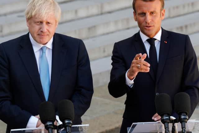 Boris Johnson gives a press conference alongside Emmanuel Macron ahead of private talks