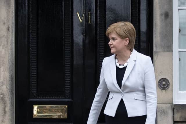 Scotland's First Minister Nicola Sturgeon outside the front door to Bute House in Edinburgh.