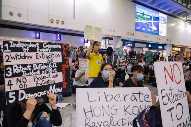 HONG KONG, CHINA - [JULY 26]: A young protester shout during the rally against a controversial extradition bill in the arrivals hall of the international airport on July 26, 2019 in Hong Kong, China. Pro-democracy protesters have continued weekly rallies on the streets of Hong Kong against a controversial extradition bill since 9 June as the city plunged into crisis after waves of demonstrations and several violent clashes. Hong Kong's Chief Executive Carrie Lam apologized for introducing the bill and recently declared it "dead", however protesters have continued to draw large crowds with demands for Lam's resignation and completely withdraw the bill. (Photo by Billy H.C. Kwok/Getty Images)