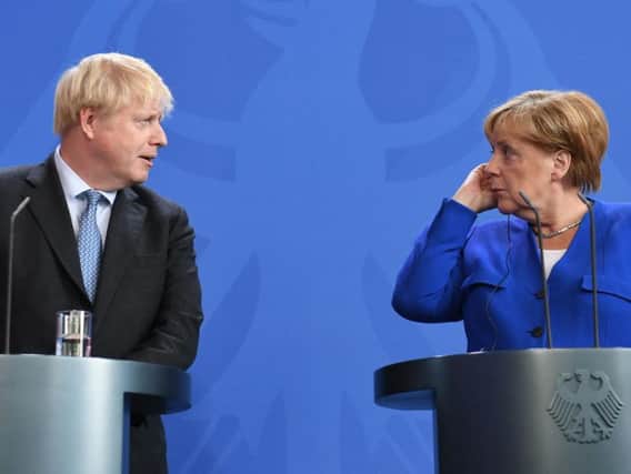 Boris Johnson holds a joint press conference with German Chancellor Angela Merkel in Berlin on Wednesday