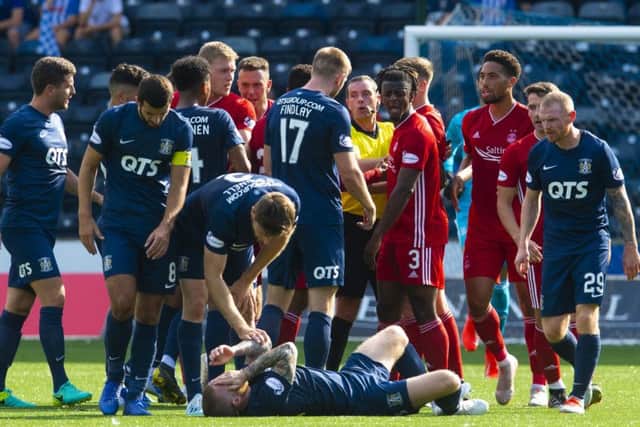 Tempers flare at Rugby Park as
Alan Power is floored by a challenge from Lewis Ferguson. Picture: Craig Foy/SNS