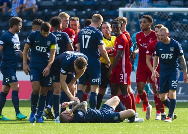Tempers flare at Rugby Park as 
Alan Power is floored by a challenge from Lewis Ferguson. Picture: Craig Foy/SNS