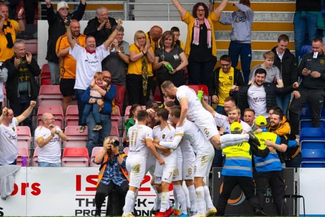 Livingston players celebrate the fourth goal.