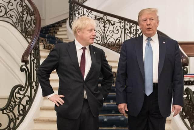 Donald Trump and Boris Johnson arrive for a meeting during the G7 summit. Picture: Stefan Rousseau / Getty Images