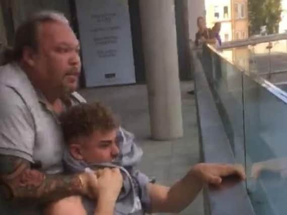 A John Lewis security guard has lost his job after a video emerged of him putting a teenager in a headlock.