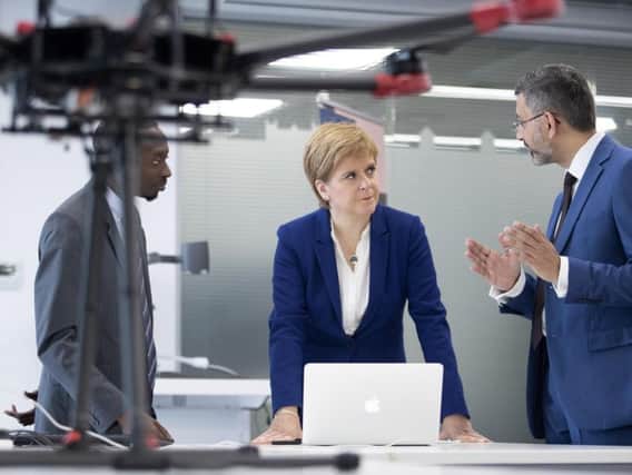 First Minister Nicola Sturgeon meets Dr Yusuf Sambo (L) and Prof Muhammad Imran (R) at the University of Glasgow. Photo: Jane Barlow - WPA Pool/Getty Images.