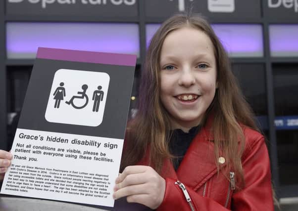 Grace Warnock, pictured in 2017,  with her new logo for the disabled toilets to show that your disability doesn't have to be visible for it to count..