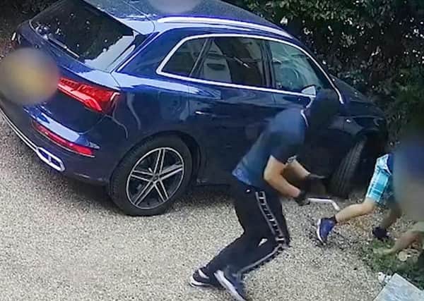 A hero mum who was caught on camera fighting off three carjackers on her driveway said her instinct was to protect her three-year-old son who was still inside the vehicle. Picture: SWNS