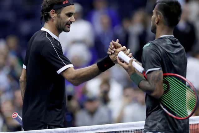 Roger Federer shakes hands with Sumit Nagal of India. Picture: Matthew Stockman/Getty Images