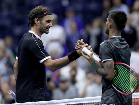 Roger Federer shakes hands with Sumit Nagal of India. Picture: Matthew Stockman/Getty Images