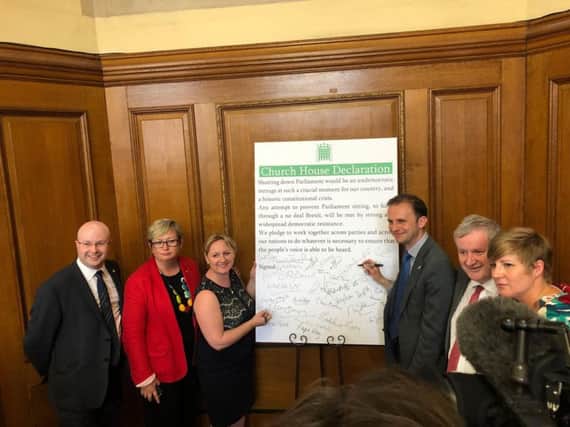 SNP Westminster leader Ian Blackford signs a declaration at Church House against a no-deal Brexit alongside several of his MPs