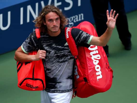 Stefanos Tsitsipas was penalised for a coaching violation and a time violation, and was overheard saying to umpire Damien Dumusois "you're all weirdos"