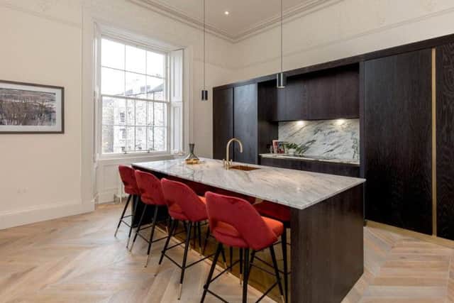 The sleek kitchen also has space for dining.