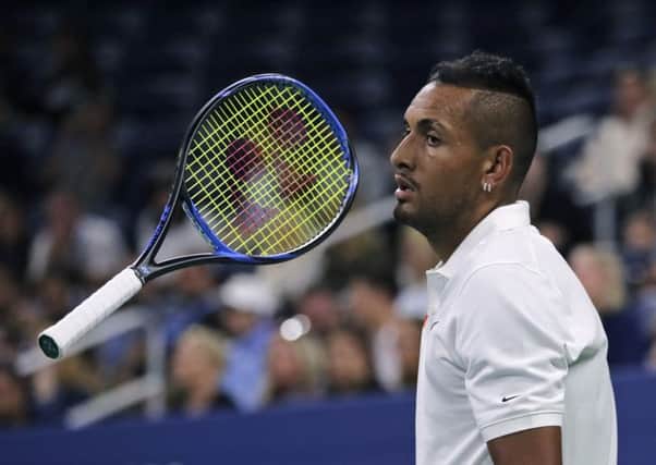 Nick Kyrgios flips his racket as he waits for Steve Johnson to serve during their. Picture: Charles Krupa/AP