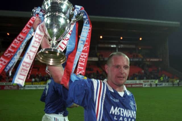 Paul Gascoigne celebrates Rangers clinching the Premier Division trophy - and their ninth title in a row - at Tannadice in May 1997. Picture: SNS