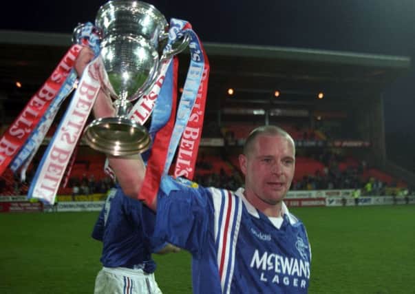 Paul Gascoigne celebrates Rangers clinching the Premier Division trophy - and their ninth title in a row - at Tannadice in May 1997. Picture: SNS