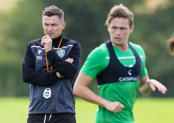 Hibs manager Paul Heckingbottom observes Scott Allan during training. Picture: Ross MacDonald /SNS
