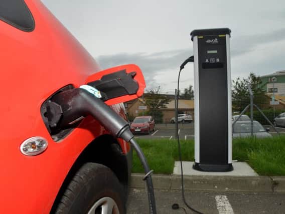 An electric car charging. More charging points will be introduced across Scotland