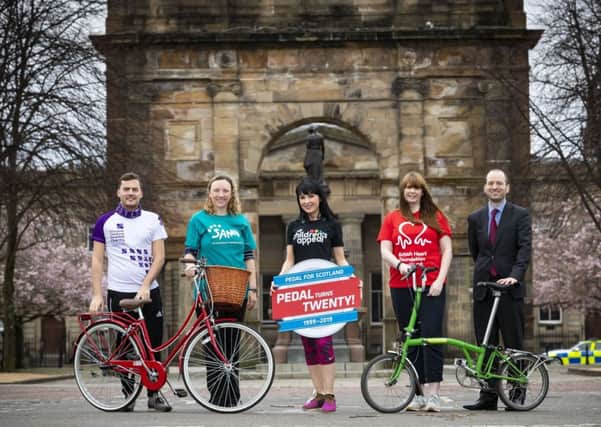 Cyclists at the McLennan Arch at Glasgow Green park where the Pedal for Scotland begins. Picture: Roddy Scott/Pedal for Scotland
