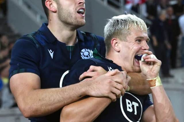 Darcy Graham, right, celebrates his try with Scotland team-mate Blair Kinghorn. Picture: AFP/Getty Images