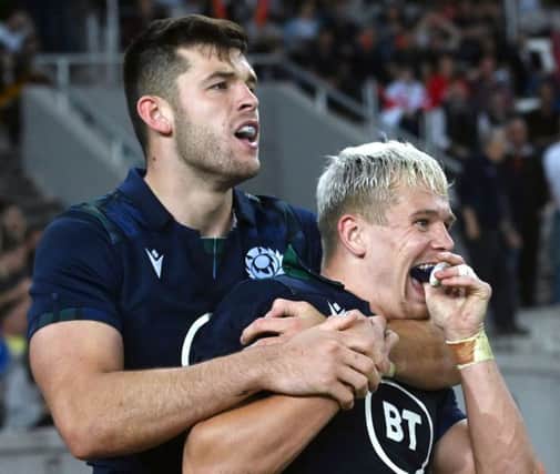 Darcy Graham, right, celebrates his try with Scotland team-mate Blair Kinghorn. Picture: AFP/Getty Images
