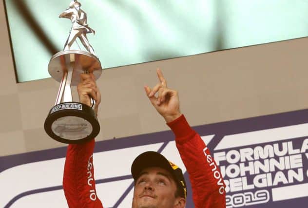 Ferrari's Charles Leclerc lifts the trophy and points to the sky after winning the Belgian Grand Prix. Picture: Francisco Seco/AP