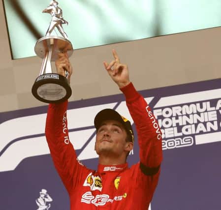 Ferrari's Charles Leclerc lifts the trophy and points to the sky after winning the Belgian Grand Prix. Picture: Francisco Seco/AP