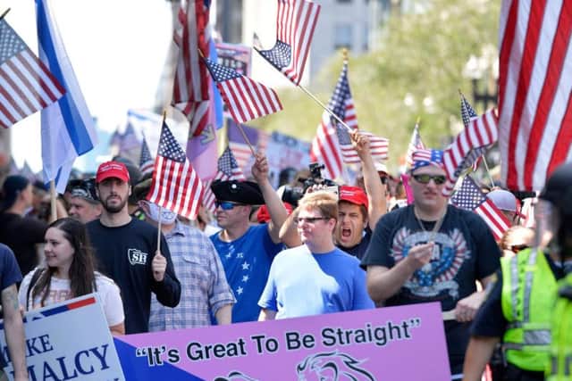 Marchers carried signs such as '2020 Trump' and 'Build The Wall'.