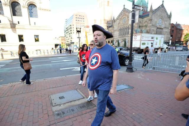 John Hugo enters Copley Square and greets police officers before the march.