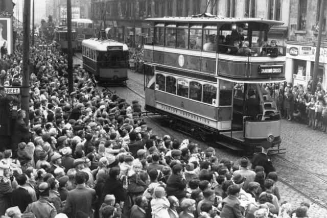 Many of those gathered ducked down to place a penny on the tracks so it would be squashed by the approaching tram to leave a unique souvenir of the day.