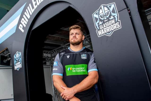 Oli Kebble helps unveil Glasgow Warriors' new home kit as he signs a contract extension at Scotstoun