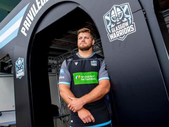 Oli Kebble helps unveil Glasgow Warriors' new home kit as he signs a contract extension at Scotstoun