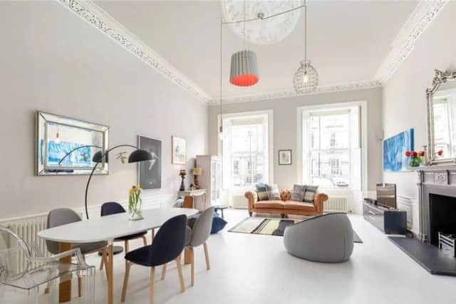 The living room has a traditional fireplace and room for a dining table, making it an ideal family living space.
