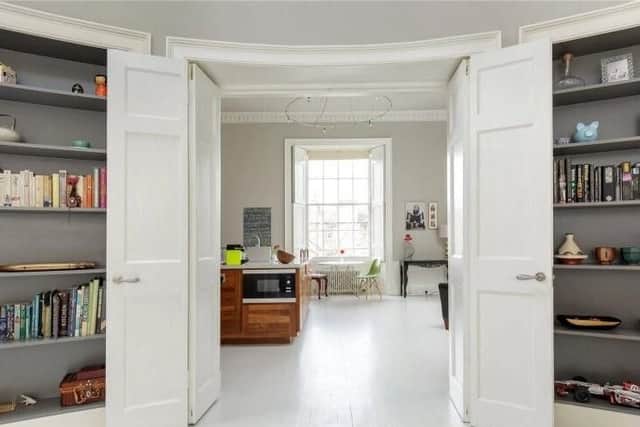 The living and kitchen areas are separated by large doors, which can be opened up to create a large living area.