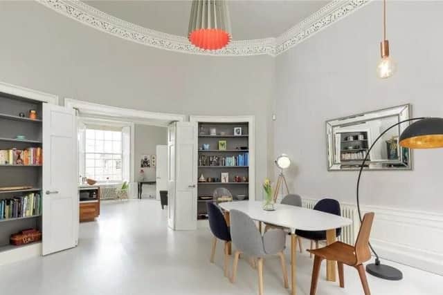 Current owners have made the most of the room's proportions by creating a living and dining area in the spacious living room. Storage has also been built in.