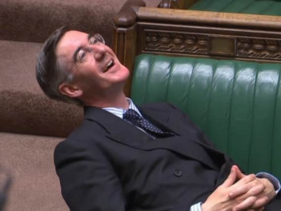 Jacob Rees-Mogg outstretched across the front benches of Parliament. Picture: PA