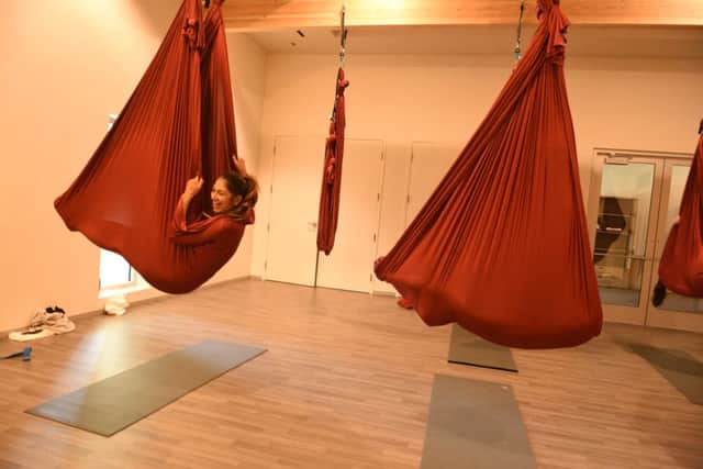 Aerial yoga involves gentle aerobics in a hammock suspended a few feet off the ground, and is fun to perfect. Picture: Lisa Young