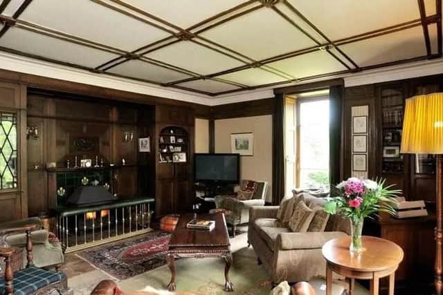 The drawing room has a large fireplace and vaulted ceiling.