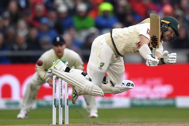 Australian batsman Travis Head overbalances after being caught out by a yorker from Ben Stokes. Picture: Gareth Copley/Getty