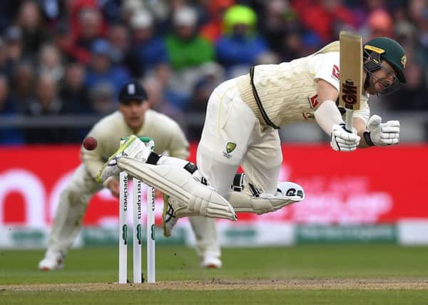 Australian batsman Travis Head overbalances after being caught out by a yorker from Ben Stokes. Picture: Gareth Copley/Getty