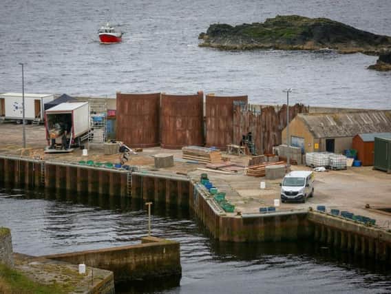 Production teams for the Netflix TV series The Crown construct various out buildings on Lybster Harbour in Caithness. The set will replicate Port Leith in South Georgia. Picture: SWNS